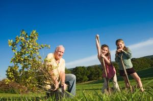 Grandfather+and+granddaughters+planting+tree